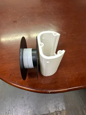 LW-PLA filament spool next to a freshly printed fuselage section